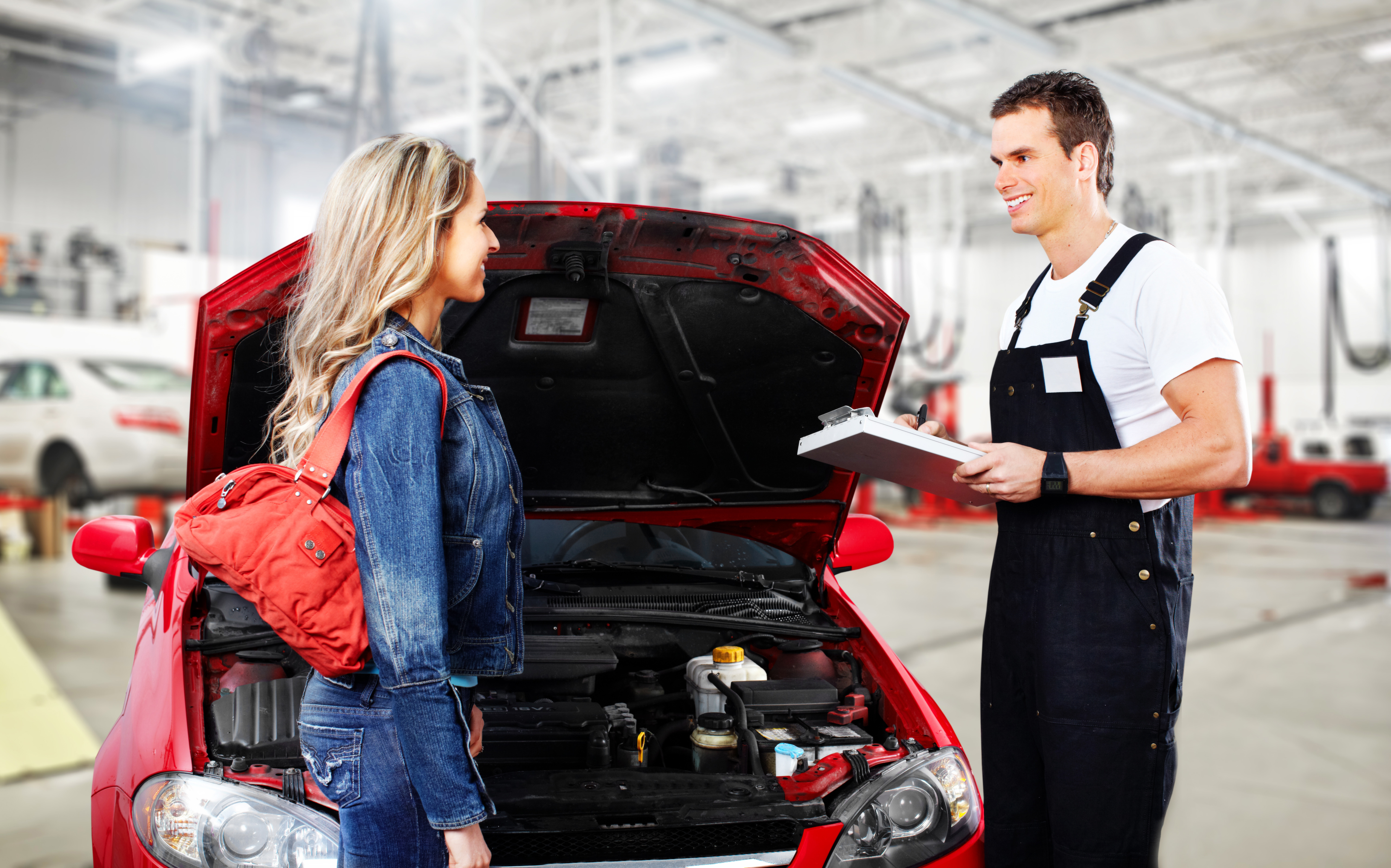 Car mechanic reviewing diagnosis with customer